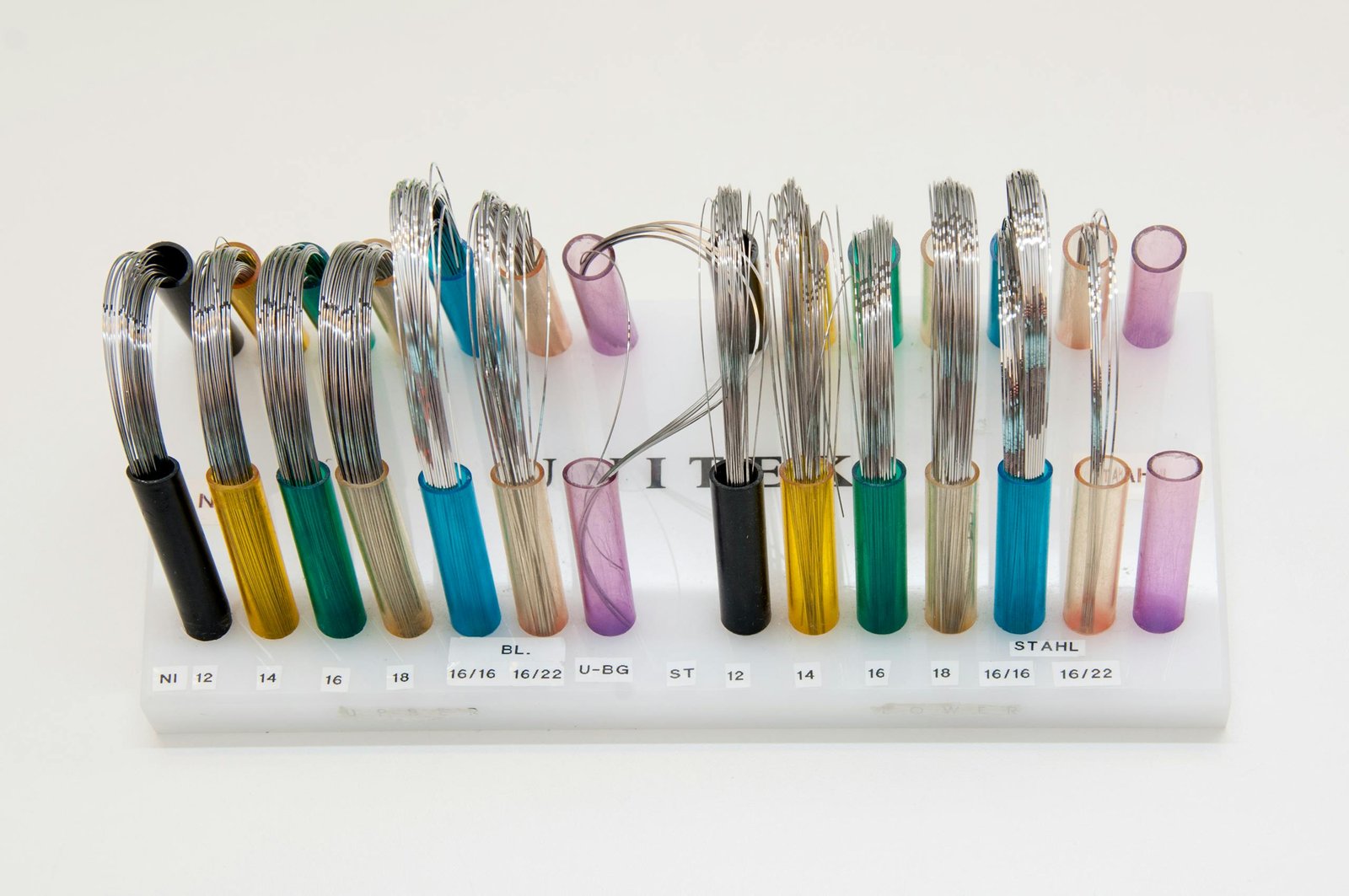 Braces Colors Display of colorful orthodontic wires arranged neatly on a stand.