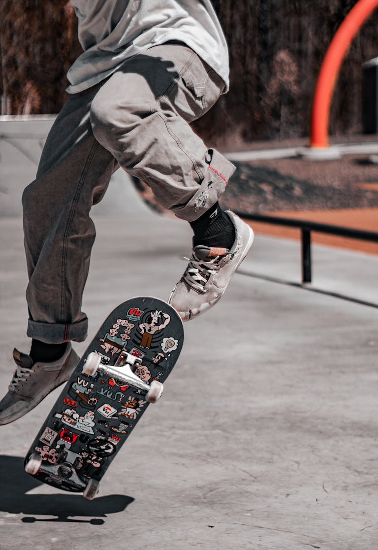 Baltimore Orioles Skateboarder performing a mid-air trick at a sunny Baltimore skatepark.