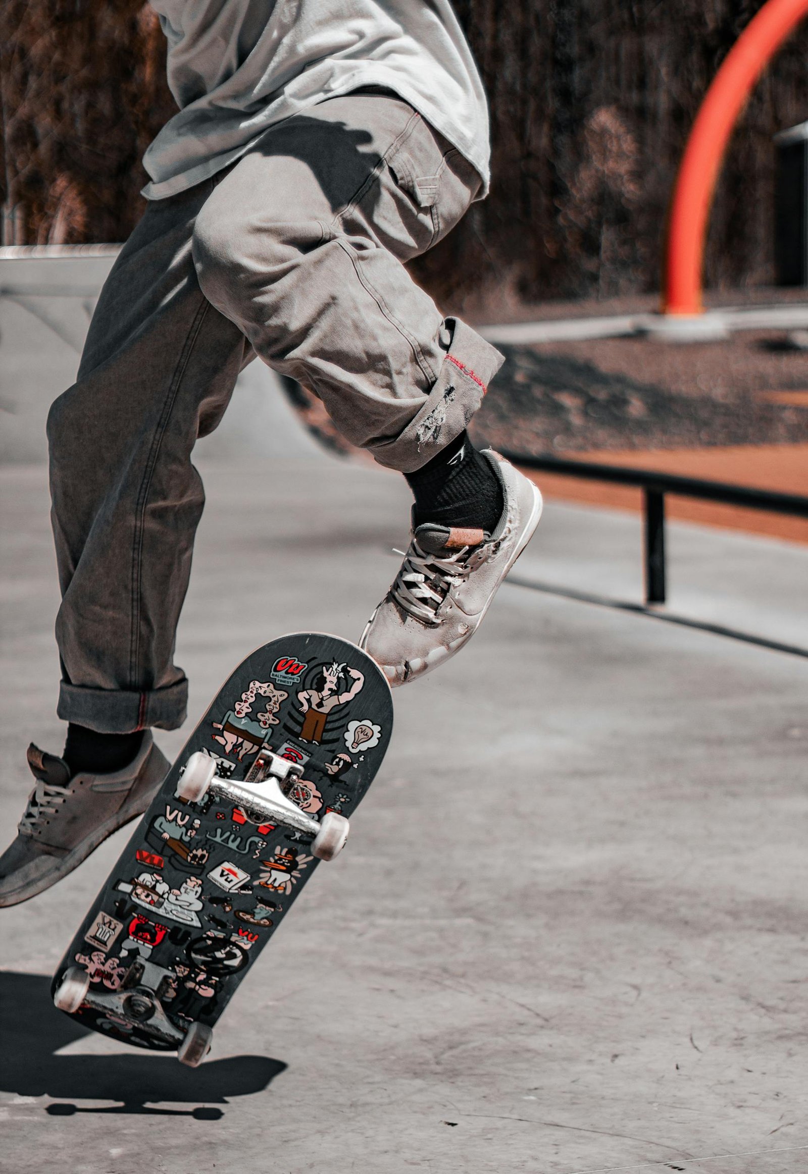Baltimore Orioles Skateboarder performing a mid-air trick at a sunny Baltimore skatepark.