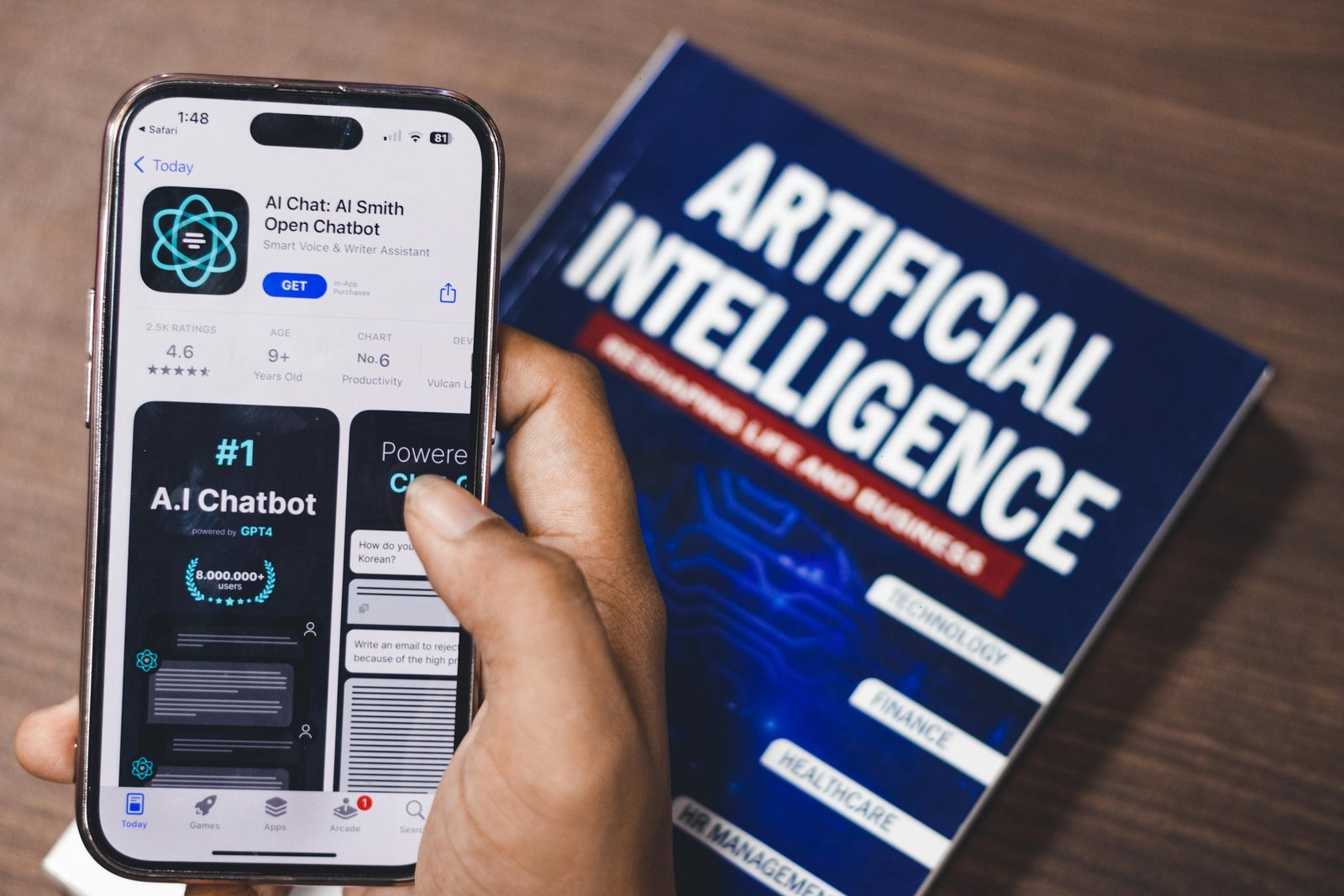 Smartphone displaying AI app with book on Stormuring AI technology in background.
